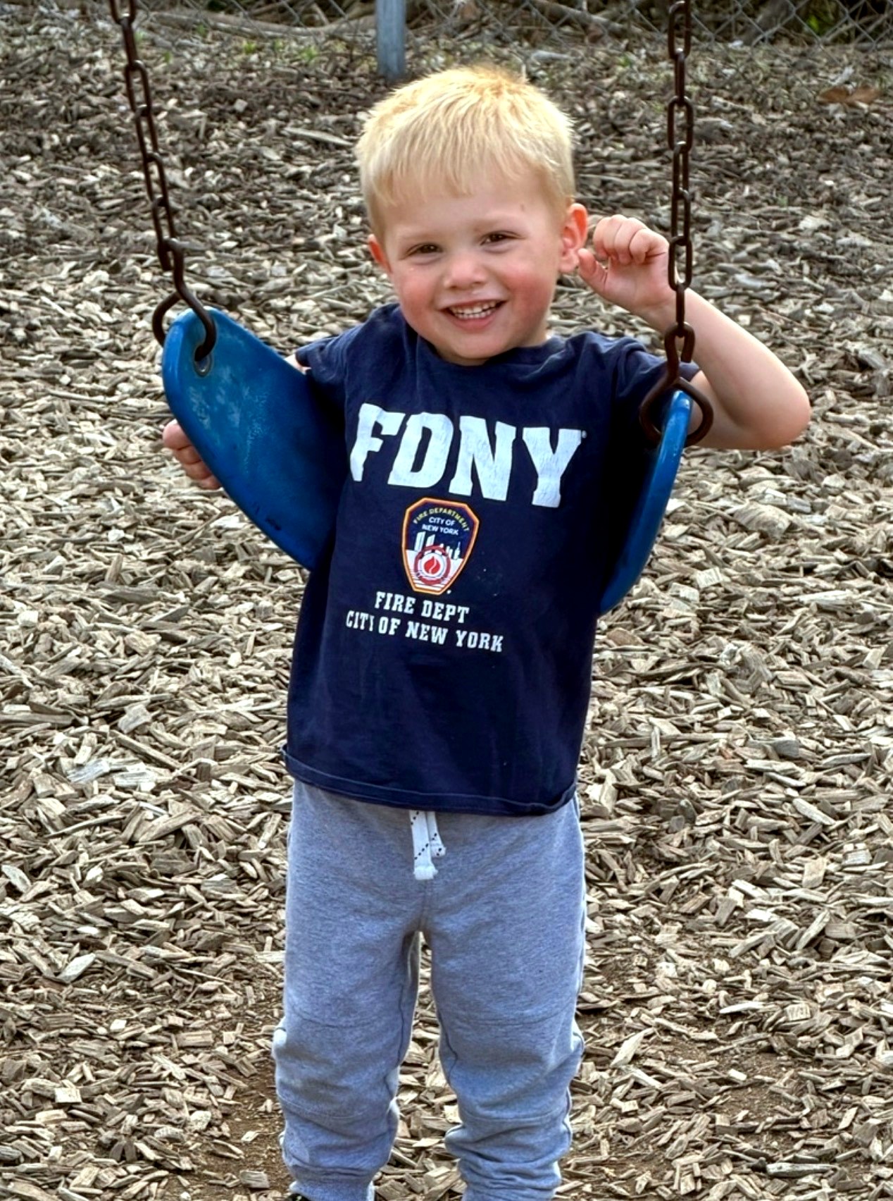 Toddler enjoying the playground swing at The Learning Tree